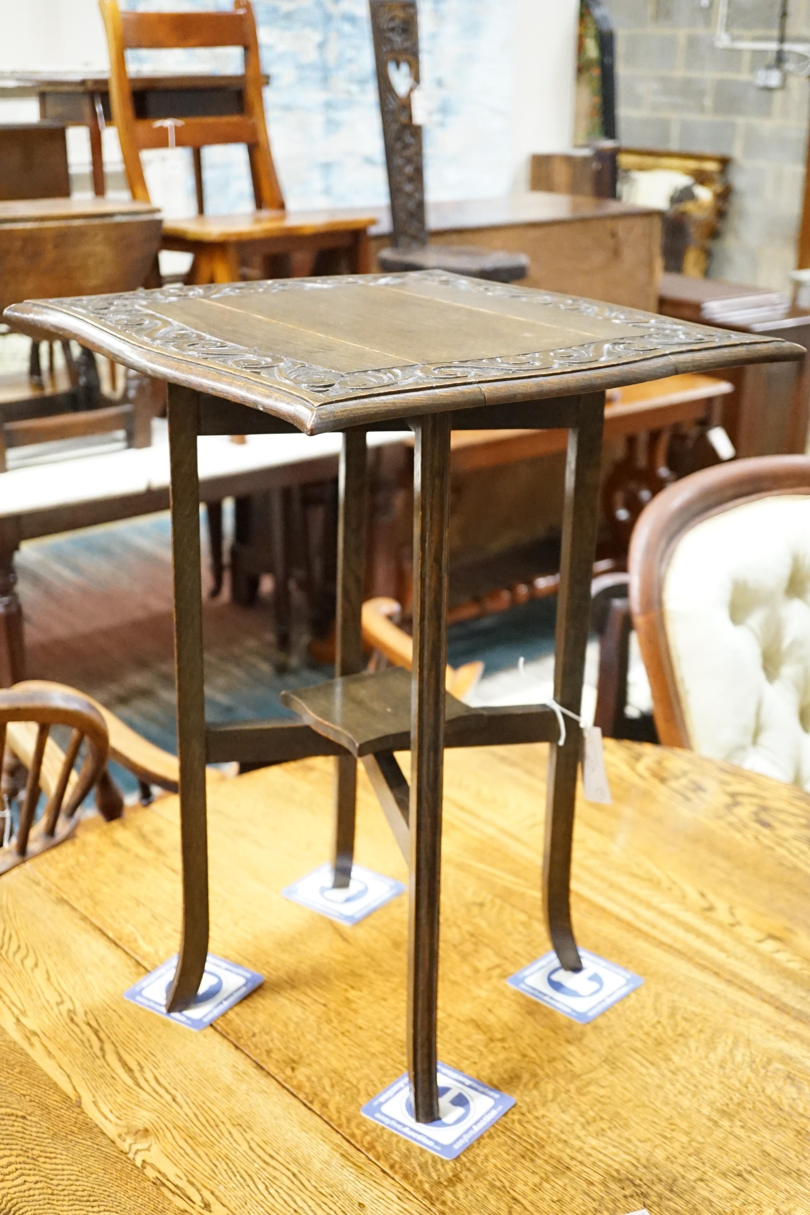 A 1920's oak gateleg table opens to 117 x 90cm and an Edwardian carved oak folding occasional table, width 45cm